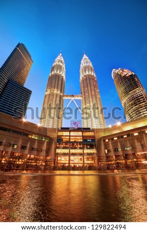 KUALA LUMPUR, MALAYSIA - FEBRUARY 8: View of Petronas Twin Tower from Symphony Lake during evening of February 8, 2012 in Kuala Lumpur. Petronas Twin Tower is the highest twin buildings in the world.