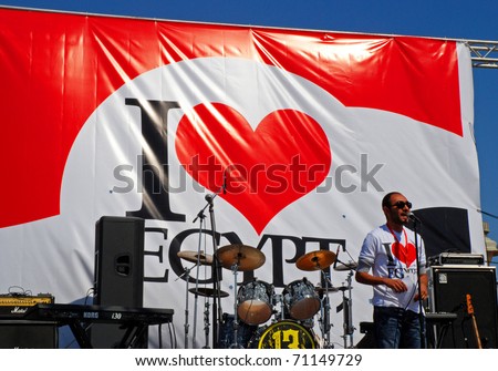 HURGHADA, EGYPT - FEBRUARY 14: Unidentified man greets the crowd at an \'I Love Egypt\' street party on February 14, 2011 in Hurghada, Egypt.