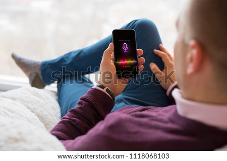 Man using virtual assistant app on mobile phone