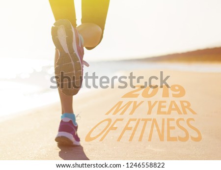 Woman running on the beach. Concept of new years resolution to get fit.