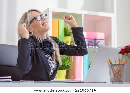 Happy young business woman enjoying success at work