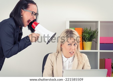 Angry boss shouting at employee on megaphone