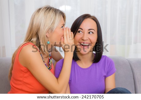 Two female friends gossip