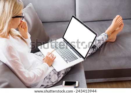Busy woman working with computer at home