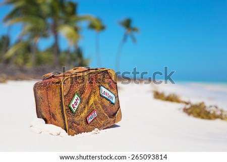 Travel suitcase toy on the beach