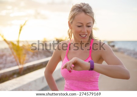 Woman checking her fitness smart watch device