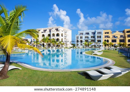 Swimming pool by the luxury resort hotel buildings