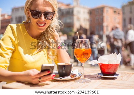 Woman enjoying day in outdoor cafe