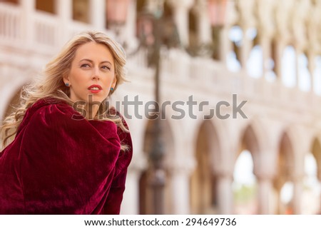 Portrait of mysterious woman in red cloak