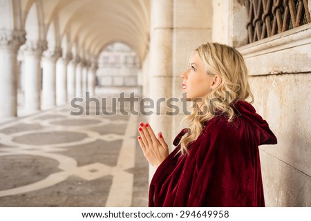 Woman in red cloak pray