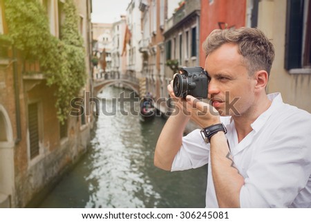 Tourist in Venice taking pictures with digital camera