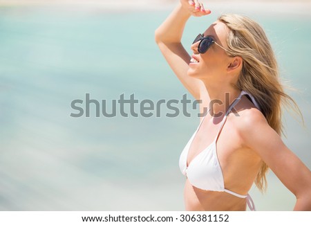 Woman looking into distance on the beach