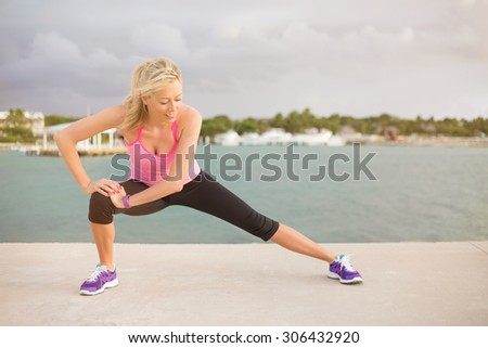Runner stretching outdoors in early morning