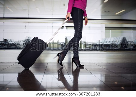 Woman with hand luggage in airport