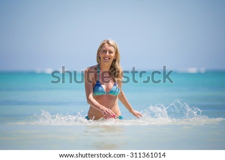 Smiling woman coming out of water
