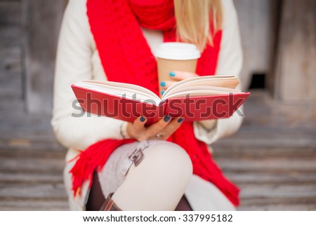 Woman sitting outside and reading