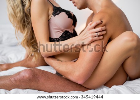 Man kissing woman\'s breasts