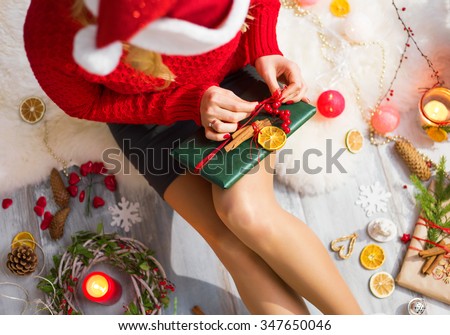 Woman unwrapping Christmas gifts