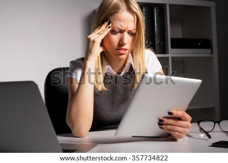 Worried woman looking at tablet