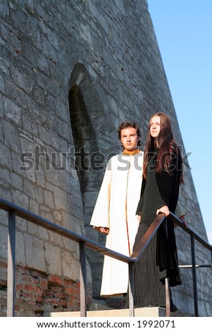 Young prince and princess in a medieval place with castle ruin