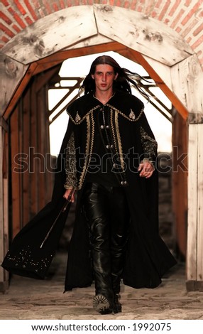 Young medieval blade-smith sword-cutler prince with black mantle like highlander