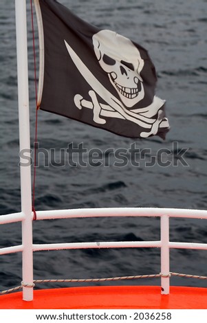 Pirates boat with black flag on the sea in a rainy day