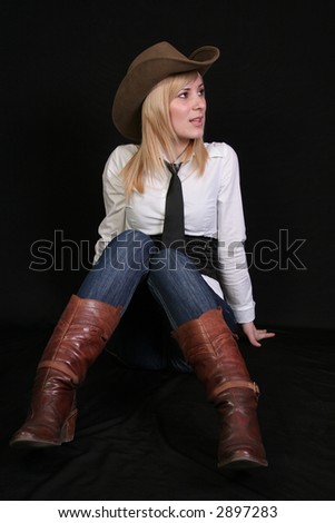 Blonde cowgirl in studio with cowboy hat