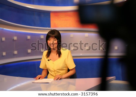 TV reporter presenting the news in studio