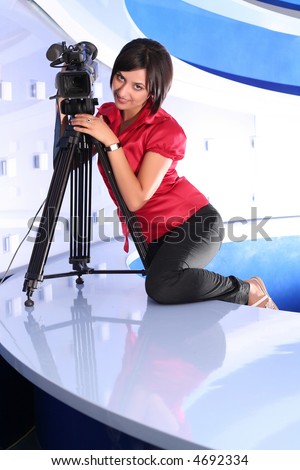 Young woman reporter posing like a photo model in TV studio