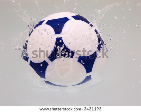 Soccer ball splashing in water