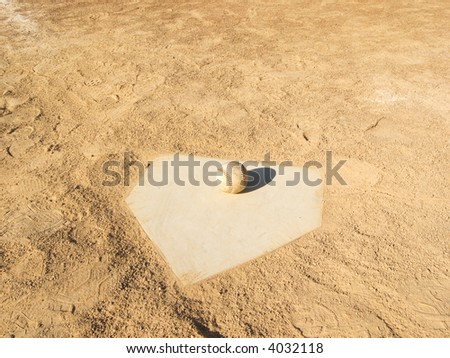 Baseball on home plate of a baseball field