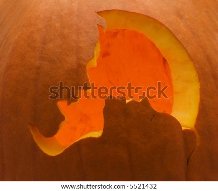 Pumpkin with a vampire about to bite woman carved out of it
