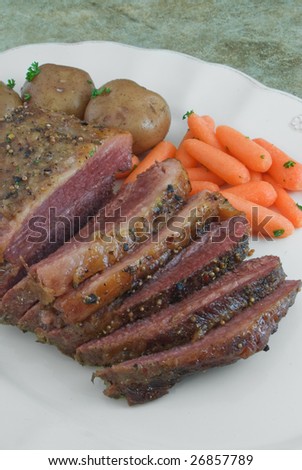 Sliced corned beef brisket with potatoes and carrots