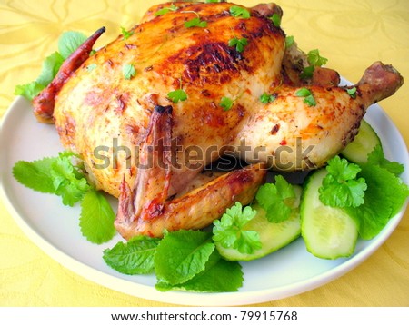 Roasted whole chicken on a plate with vegetables