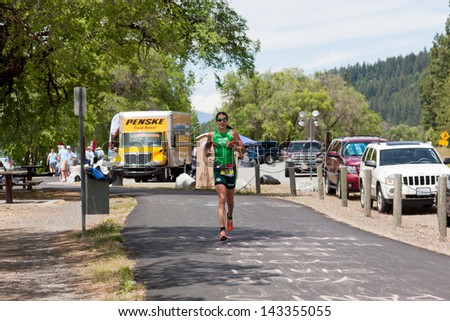 COEUR D ALENE, ID - JUNE 23: Heather Wurtele of Canada runs at the June 23, 2013 Ironman Triathlon in Coeur d\'Alene, Idaho. Heather took first place in the woman\'s division with a time of 9:16:02.