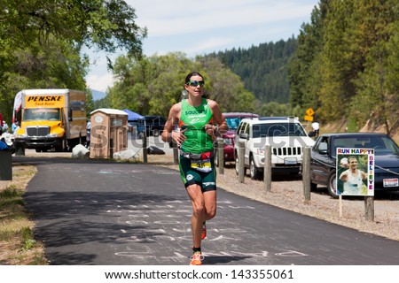 COEUR D ALENE, ID - JUNE 23: Heather Wurtele of Canada runs at the June 23, 2013 Ironman Triathlon in Coeur d\'Alene, Idaho. Heather took first place in the woman\'s division with a time of 9:16:02.