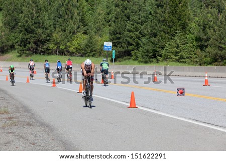 COEUR D ALENE, ID - JUNE 23: Matthew Russell on bike  at the June 23, 2013 Ironman Triathlon in Coeur d\'Alene, Idaho.
