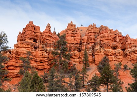 Erosion effecting the sandstone mountains and leaving towering pillars at the entrance of Red Canyon in Dixie National Park, Utah.