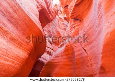 Bright orange sandstone walls in Antelope Canyon Arizona that have been eroded to a smooth surface.