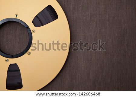 Professional audio metal reel on brown background