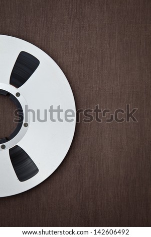 Professional audio metal reel on brown background
