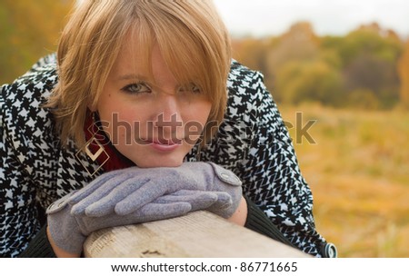 Portrait of a young woman of Caucasian appearance with gloves and coat outdoors