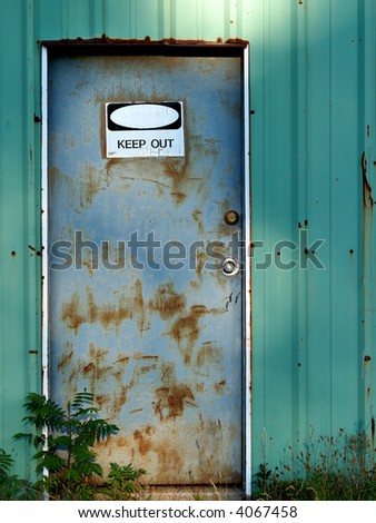 A rusty old door in the side of a rusty old shed tells visitors to Keep Out