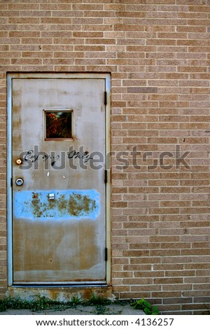 Grungy Employee Only door into the side of an old building