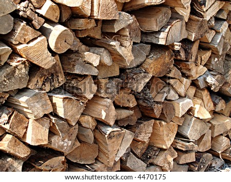 Large stack of split wooden logs ready to be added to the fire