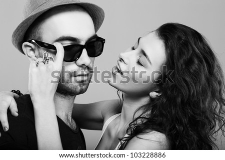 A young beautiful girl is flirting with a guy in a hat - Indoors
