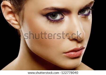 beautiful female face with natural makeup, on black background