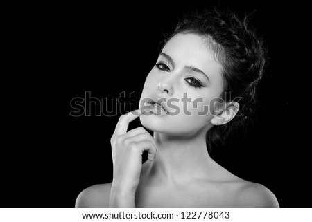 beautiful female face with natural makeup, on black background
