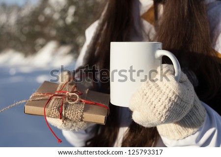 girl attractive drinking tea over winter nature background outdoor