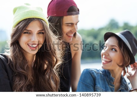 Active people. Closeup of group of young two women and one man. Outdoors, lifestyle